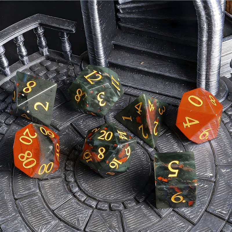 Close-up of natural bloodstone D20 die for tabletop RPG — deep green chalcedony with red iron oxide spots