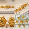 7-piece metal DND dice set — warm copper-gold with hollow floral cut-out patterns