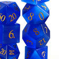 7-piece cat's eye stone DND dice set — deep cerulean blue with white light band with chatoyant shimmer