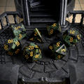 Close-up of kambaba jasper D20 die for tabletop RPG — dark green with ancient orbicular black patterns
