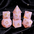 rose pink with soft milky inner glow crystal dice close-up — engraved numerals for DND