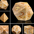 Close-up of chrysanthemum stone D20 die for tabletop RPG — midnight black with white floral crystal patterns