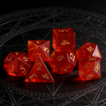 Close-up of red cat's eye stone D20 showing light band effect — tabletop RPG dice