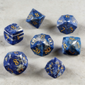 7-piece lapis lazuli DND dice set including D4 D6 D8 D10 D12 D20 — deep blue with gold veining and diamond-cut facets