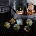 7-piece labradorite DND dice set including D4 D6 D8 D10 D12 D20 — dark grey with electric blue and gold iridescence