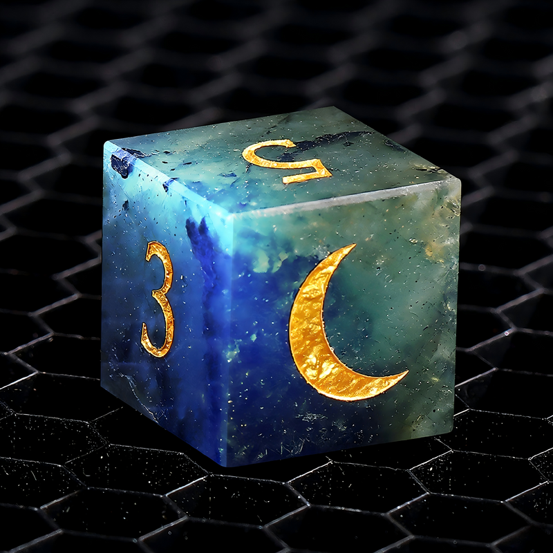 Close-up of labradorite D20 die for tabletop RPG — dark grey with electric blue and gold iridescence