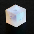 Close-up of K9 crystal D20 die — frosted exterior with internal rainbow fractures for tabletop RPG
