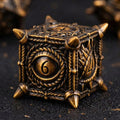 Close-up of dark charcoal with golden dragon eye motifs metal D20 die for tabletop RPG