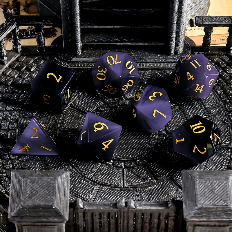 7-piece cat's eye stone DND dice set — royal violet with luminous white eye band with chatoyant shimmer