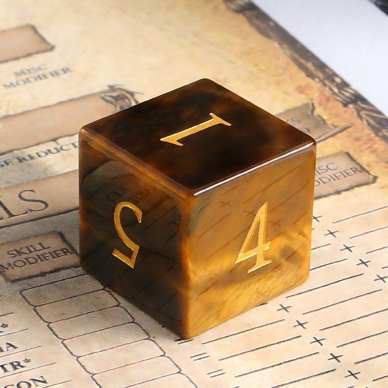 Close-up of tiger's eye stone D20 showing light band effect — tabletop RPG dice