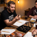 dark charcoal with golden dragon eye motifs metal dice detail — deep-engraved numerals for D&D